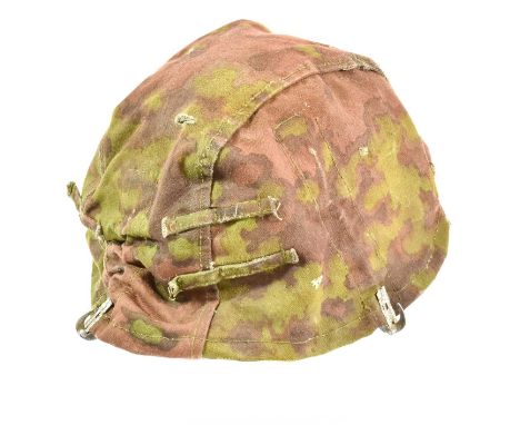 A Second World War German Waffen-SS Reversible Camouflage Cover for a Steel Helmet, in oak leaf pattern cotton for Spring and