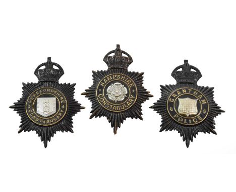 Three Blackened Die Stamped Brass Helmet Plates, each with King's crown over circlet and white metal coat of arms, to:- Grant