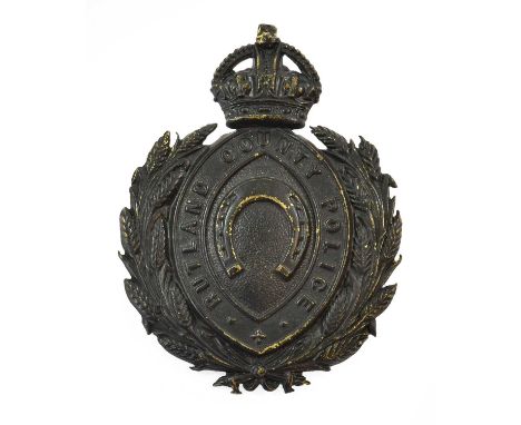 A Rutland County Police Helmet Plate, in blackened die stamped brass with King's crown over a wreath, circlet and horseshoe, 