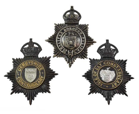 Two Blackened Die Stamped Brass Helmet Plates, each with King's crown over circlet and white metal coat of arms, the reverse 