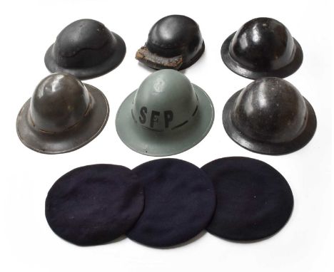 Nine Pieces of Second World War Headgear, comprising two Civil Defence Composition Brodie Helmets, one with moulded mark unde