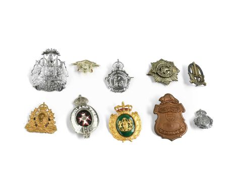 A Royal Canadian Mounted Police Force Cap Badge, in gilt metal with King's crown; a Queensland Police Helmet Plate, in cast s