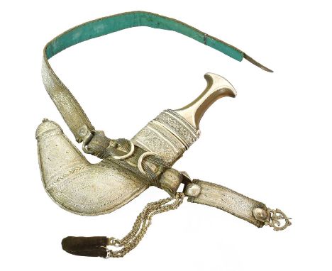 An Early 20th Century Omani Khanjar, the 19cm double edge curved steel blade with raised medial ridge, the horn grip with sil