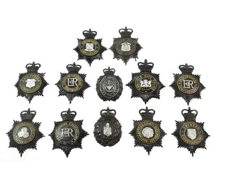 Seven Elizabeth II Police Helmet Plates, each in blackened brass with QEII crown over star, circlet and applied white metal c