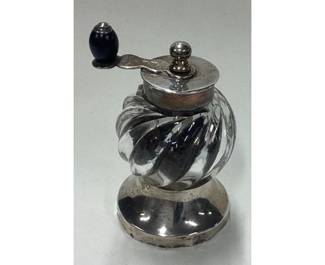 A Victorian silver and glass pepper grinder. Birmingham 1892. By Hukin & Heath. Approx. 201 grams. Est. £100 - £150.