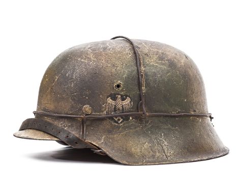 A Third Reich M42 single decal steel helmet, with textured camouflage finish, army eagle decal and stout camouflage wire, the