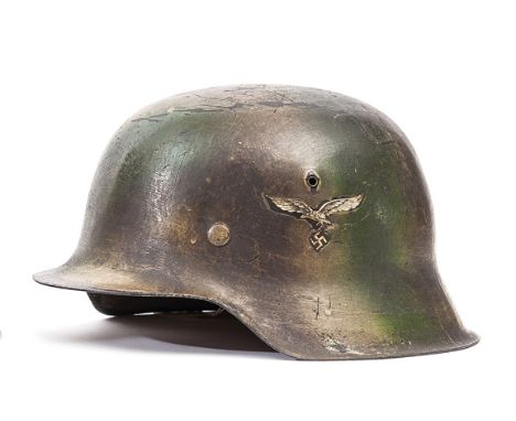 A Third Reich M42 single decal Luftwaffe steel helmet, with smooth camouflage finish around 2nd pattern Luftwaffe eagle, with