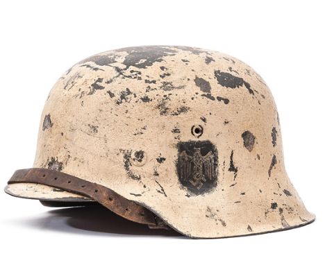 A Third Reich M42 single decal steel helmet, with textured white snow camouflage finish around the army eagle decal, with lea
