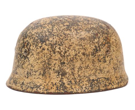 The shell only of a Third Reich paratrooper’s helmet, with “ET” maker’s stamp (Eisenhutterwerke in Thale), white painted fini