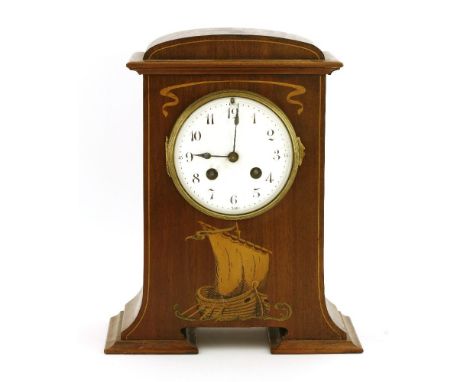 A mahogany and boxwood inlaid mantel clock,with an enamelled Arabic dial, above an inlaid galleon,22cm wide28cm high
