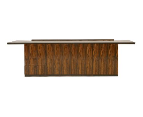 A rosewood console, § c.1970, the plain top over three modular units comprising drawers and cupboards, labelled 'N H Chapman 