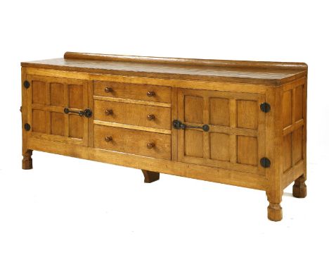 A Robert 'Mouseman' Thompson 6ft sideboard, with an adzed top with canted corners, three central drawers flanked by cupboards