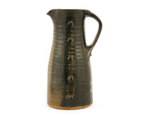 *Jim Malone (b.1946),a stoneware jug, with a black/brown glaze, with thumb details, impressed initials, 32cm high*Artist's Re