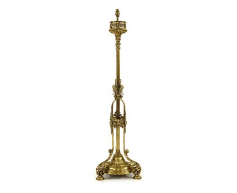 An Aesthetic brass standard lamp,late 19th century, with pierced scrolling decoration, on a circular base and scrolling acant