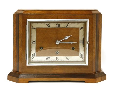An Art Deco walnut and coromandel inlaid mantel clock, with a chrome chapter ring and Westminster movement,33cm wide17cm deep