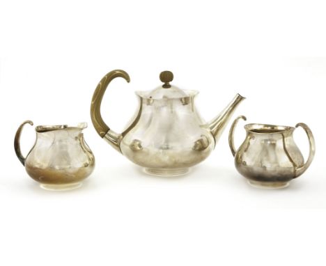 A Mappin and Webb silver-plated three-piece tea set, designed by Eric Clements, the teapot with a turned wood handle and fini