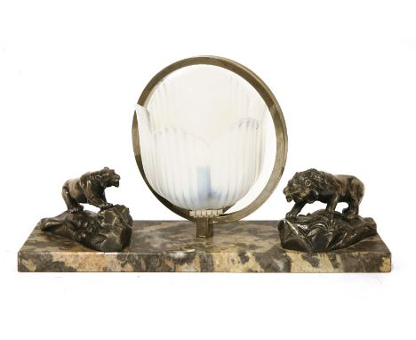 An Art Deco spelter table lamp,the moulded opalescent shade flanked with a silvered lion and tiger, on a marble plinth,37cm w