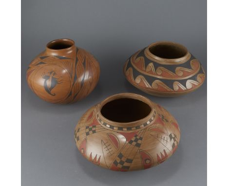 Three Mata Ortiz style pottery jars. One polychrome pottery jar with wide shoulders and decorated with two bands of a wave pa
