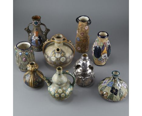 Nine Amphora art pottery pieces. Includes one baluster vase with floral and bird motifs, marked 15184, 7; one bulbous vase wi