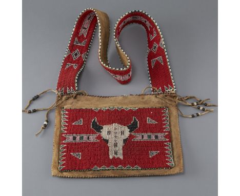 Sioux postwar bandolier bag. Leather, decorated with a red beaded panel with a cattle skull motif and geometric patterns. Str