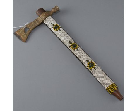 Pipe axe with beaded shaft decorated with turtle motif; cut out heart in the floral decorated brass head. One beaded rifle ca
