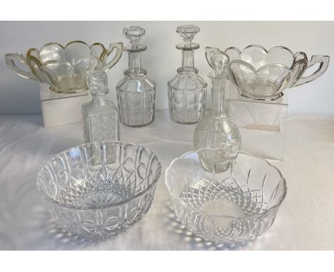 4 vintage glass decanters together with 4 large glass bowls. Includes 2 large 2 handled Chippendale fruit bowls and a pair of
