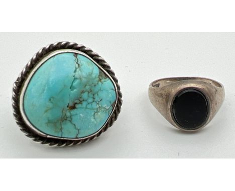 A vintage silver signet ring set with an oval of black onyx. Together with a modern design white metal ring set with a large 