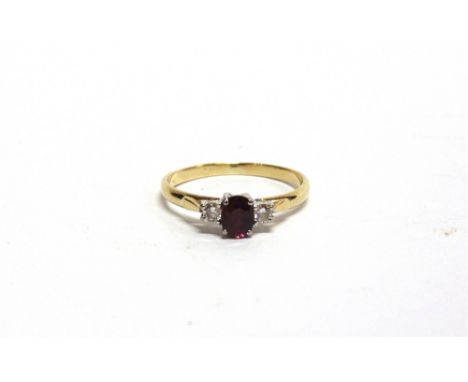 A THREE STONE RUBY AND DIAMOND 18 CARAT RING the brilliant cuts totalling approximately 0.1 carats, finger size O1/2, 2/1g gr