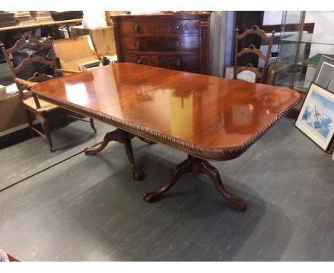 A REPRODUCTION MAHOGANY TWIN PEDESTAL DINING TABLE  with additional leaf, 105cm deep 202cm long (248cm with leaf inserted)