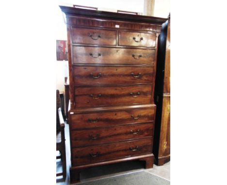 A MAHOGANY CHEST ON CHEST  with dentil frieze above two short and three long drawers to upper section flanked by canted corne