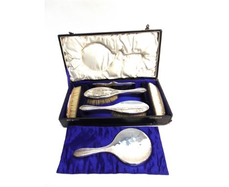 A CASED DRESSING TABLE SET  Kemps Brothers, Birmingham 1919, comprising a hand mirror; two hair brushes; two clothes brushes;