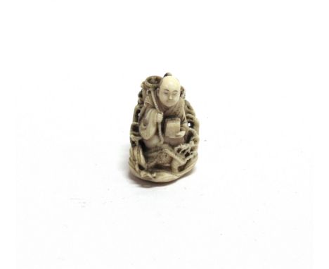 A JAPANESE IVORY NETSUKE  carved as a man sat upon waves, with character mark to base, 3.75cm high.