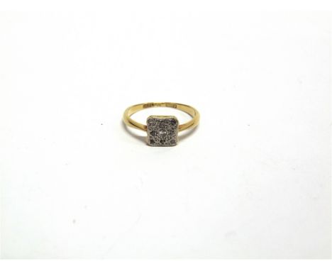 A DIAMOND PANEL RING stamped '18ct & PT'; the square head set with rose cuts and a single cut, finger size N