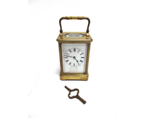 A BRASS CARRIAGE CLOCK  with enamel dial and French movement striking hours and half hours, 8.5cm wide 13.5cm high excluding 