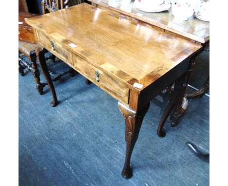 A TWO DRAWER WALNUT SIDE TABLE  on cabriole supports with carved decoration, 92cm wide 47cm deep 73cm high