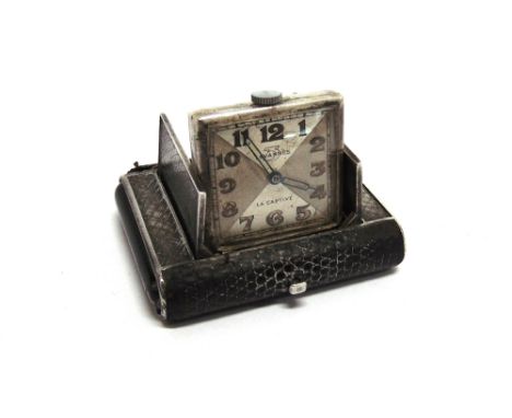 A SILVER AND ENAMEL PURSE WATCH signed Tavannes - Le Captive to the dial, the rectangular case covered in snake skins, 5.2cm 