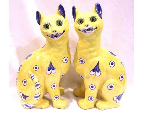 Galle Pair of ceramic yellow glazed cats with blue and white design and glass eyes, signed E Galle  Nancy, H: 32 cm. No appar