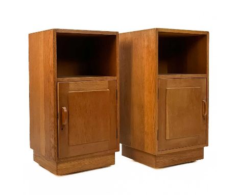 Gordon Russell (1892-1980)  A pair of oak bedside cabinets with an open shelf above a single cupboard door enclosing a single