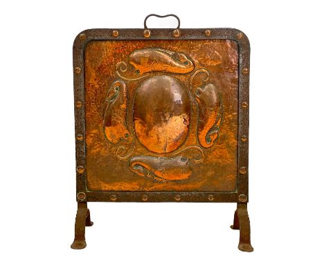 A John Pearson copper and wrought iron firescreen. Initialled and dated 1906, repousse decorated with four fish around a cent