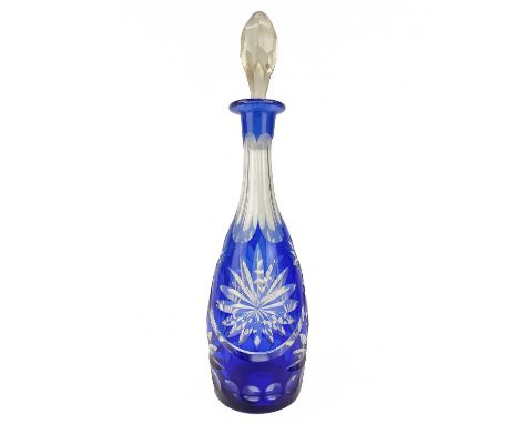 A Bohemian blue flash decanter and stopper. Height 39cm.