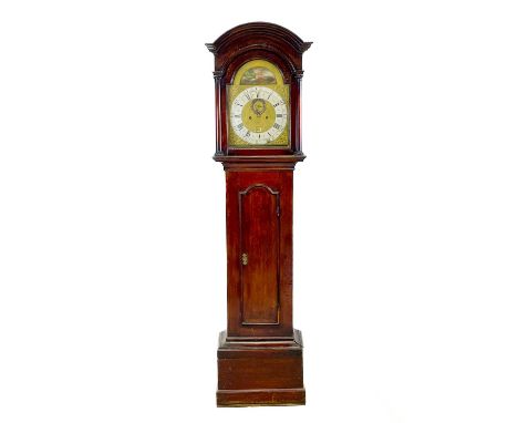 A George III eight-day longcase clock. The 30cm square brass dial with later arch, painted a country scene, contained in a la