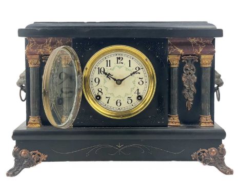 An American eight day Sessions Clock Co mantel clock. Late 19th century, in an ebonised wood case with copper finish lion's m