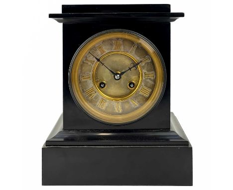 A black slate French eight day mantel clock. The matt silvered dial with gilt Roman numerals, striking on a coiled gong, heig