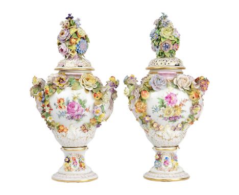 A pair of Carl Thieme Potschapel twin handled vases and pierced covers. With painted classical scenes and bouquets of flowers