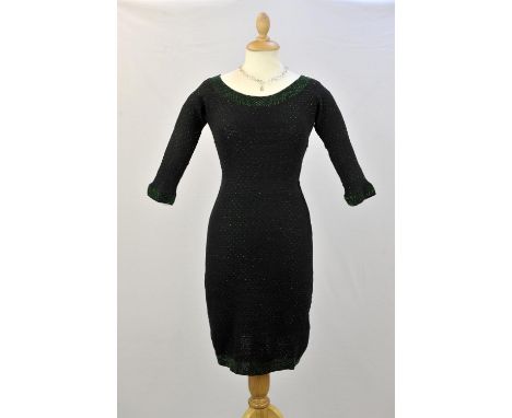 A collection of handmade fine knitted cotton garments from 1950s era. A fitted black belted cocktail dress with tiny green gl