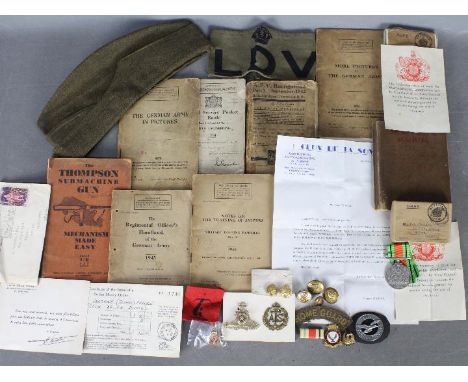 A collection of military items to include a World War Two (WW2 / WWII) defence medal with slip in box named to P J Hartley, a