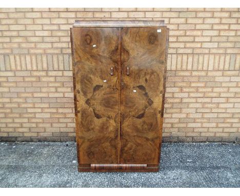 A burr walnut veneered wardrobe of small scale, twin doors with fitted interior, approximately 157 cm x 150 cm x 60 cm.