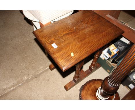 An oak occasional table and an oak and needlework firescreen