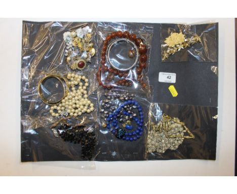 A collection of costume jewellery to include bangles; simulated pearl necklace; various bead necklaces etc.