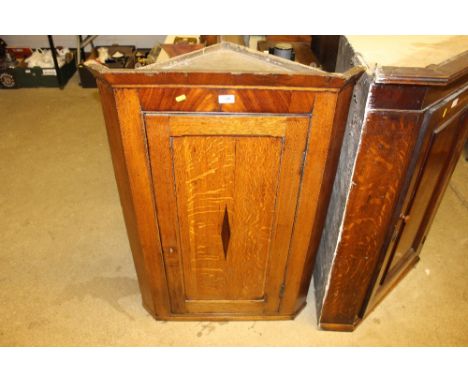 A 19th Century light oak and mahogany hanging corner cupboard